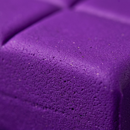 Extreme macro view of deep purple Fimo effect clay texture with shimmering glitter particles.