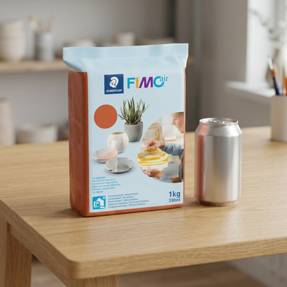 STAEDTLER Fimoair 1kg Terracotta block seen at correct scale next to a 330ml beverage can on a desk.