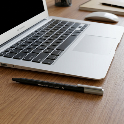 A scale reference shot showing the STAEDTLER triplus fineliner next to a laptop keyboard.