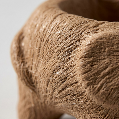 An extreme close-up photograph capturing the realistic wood fiber grain and fine textural detail of a molded, air-dried FIMO air wood effect creation.