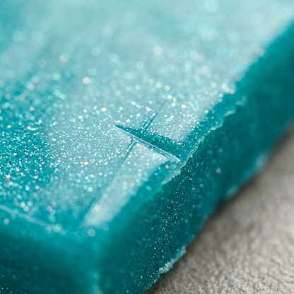 A macro detail shot of STAEDTLER Galaxy Turquoise FIMO effect clay showing precise glitter texture.