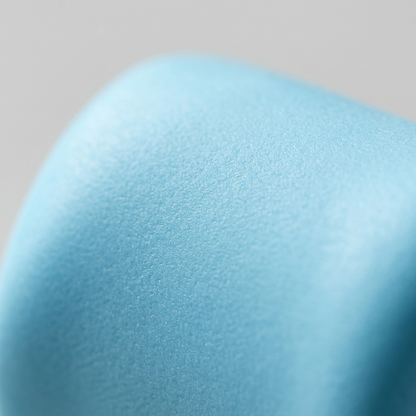 An extreme macro photograph showcasing the smooth, fine fine-grained surface of Fimo Soft Aqua polymer clay.