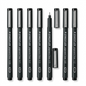 A high-resolution, centered flat lay photograph of eight Staedtler Pigment Liner technical pens, in black barrels with metallic caps, showing the range of sizes from 0.05mm to 1.2mm. All standard brand markings are visible.