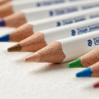 Macro photo detailing sharp tips of Staedtler watercolor pencils with fine wood grain and paint texture.