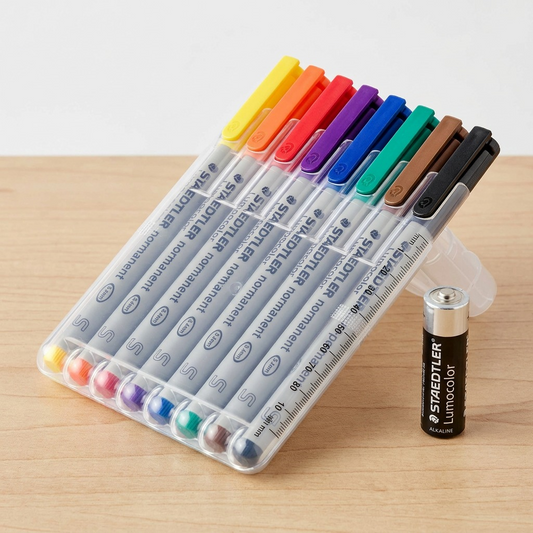 A photo of the STAEDTLER marker set next to a standard AA battery.