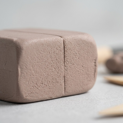 Extreme close-up of a Staedtler FIMO Professional clay block, showing its fine, granular texture and cut edge.
