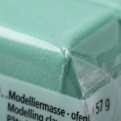 Extreme macro detail of the soft texture and precise printed text on the mint Fimo clay.