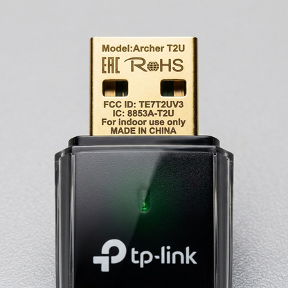 Macro view of deep-engraved details on the Archer T2U's gold USB connector and textured casing.