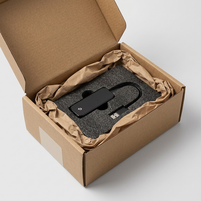 A TP-Link UE306 adapter safely surrounded by protective foam and brown paper inside an open cardboard shipping box.