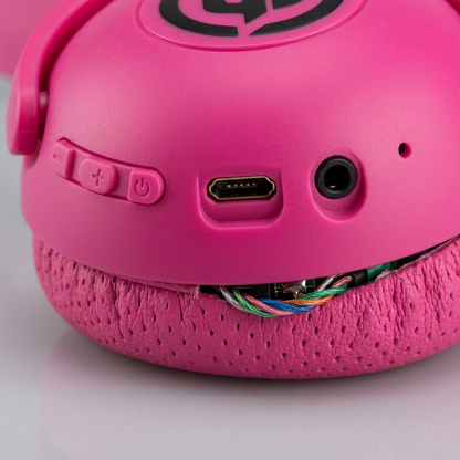 A detailed macro photo of Wicked Audio Tricky Tike headphones showing the button controls, ports, and mic.