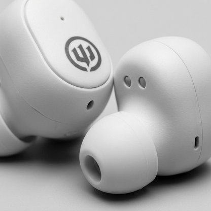 Extreme macro view focusing on the smooth matte polymer material and finely molded seams of the Wicked Audio Embr wireless earbuds.