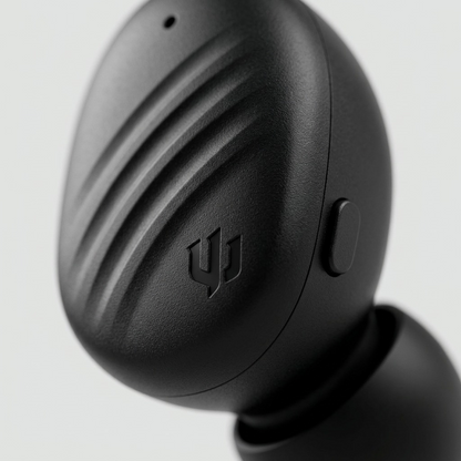 Macro close-up of Wicked Audio Mojo 300 right earbud showing textured faceplate and button.