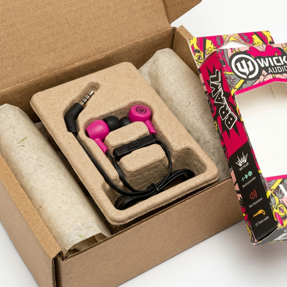 Close-up of Wicked Audio BRAWL earbuds with pink accents carefully nestled in secure cardboard packaging.
