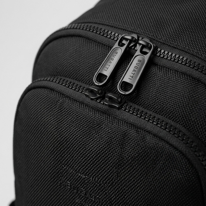 Macro detail of the Bugatti Madison Backpack showing durable black fabric and dual engraved zippers.
