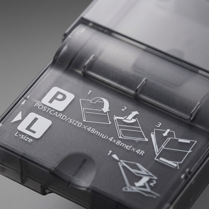 A micro close-up of the paper cassette's user interface, highlighting specific instructional guides.