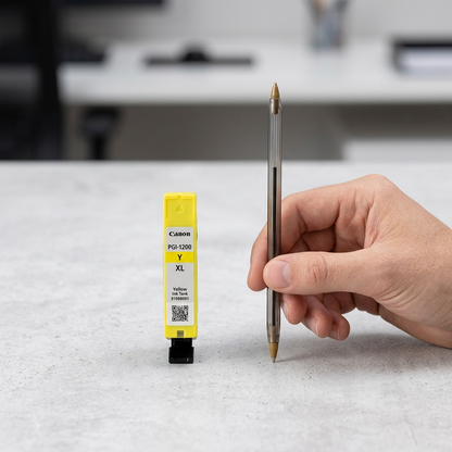 Canon PGI-1200XL Yellow Ink Tank and pen on desk.
