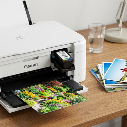 Alt Text: An installed Canon CL-276 Color cartridge and a vibrant, color-printed photo rest together on a desk.