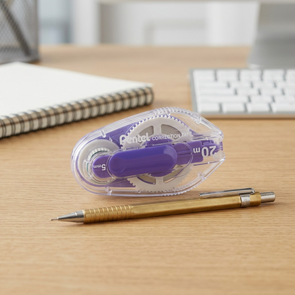 Pentel Retractable Correction Tape alongside a mechanical pencil on a desk for size reference.