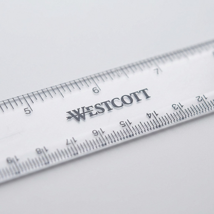 Macro photograph focusing closely on the sharp black markings, WESTCOTT logo, and fine gradations on a translucent, slightly textured ruler.
