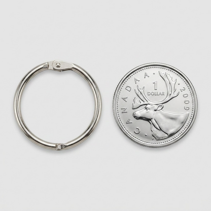 A 1-inch metal card ring shown next to a 1-dollar Canadian coin for scale confirmation.