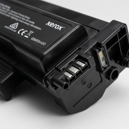 Extreme close-up of a Genuine Xerox Black High Capacity Toner Cartridge, highlighting a precise end connector and the matte black texture.